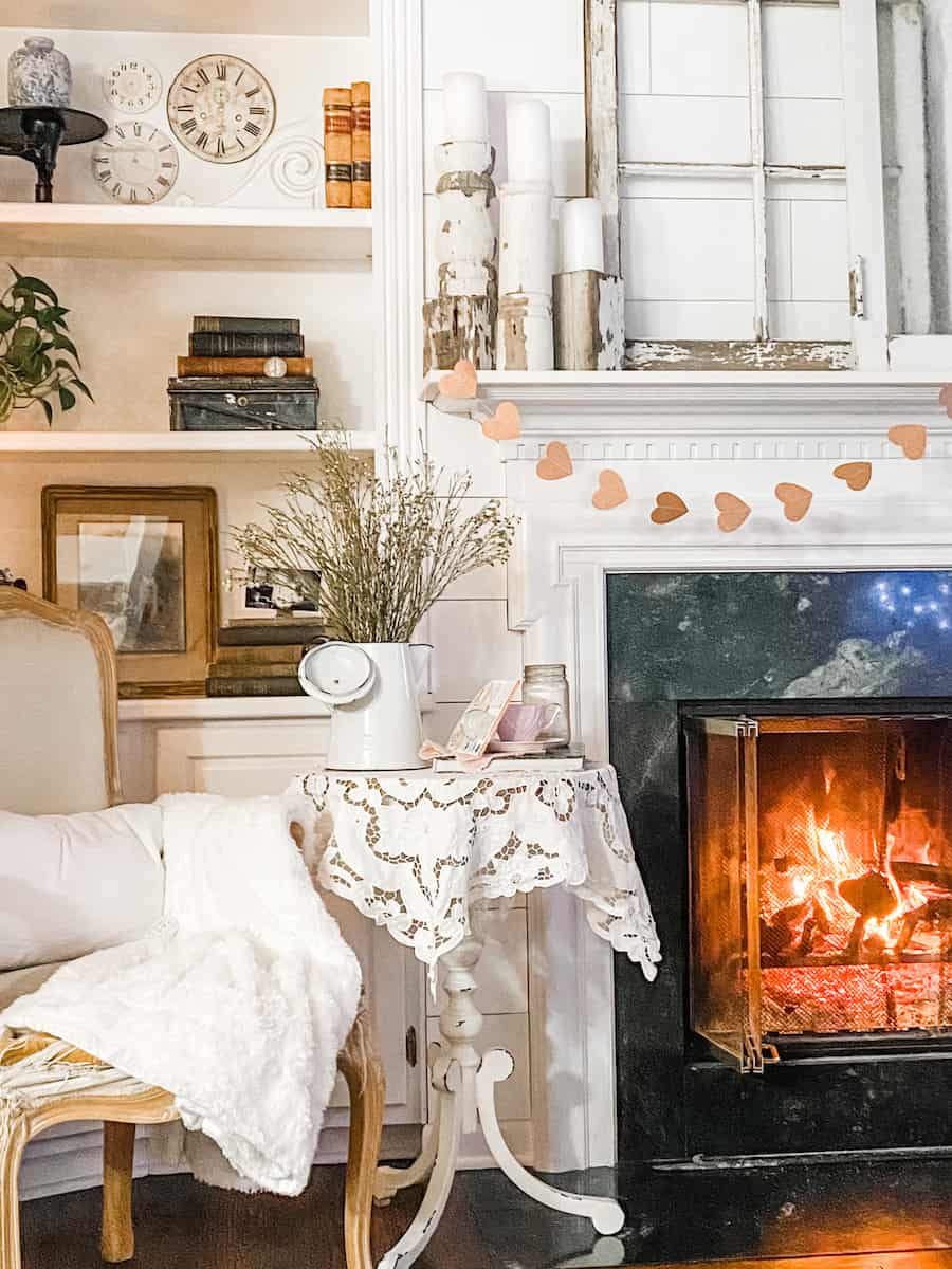 sharing how to make a cozy home with a comfy chair next to a roaring fire
