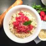 picture of tomato basil pasta in a bowl with French bread and parmesan cheese on the side