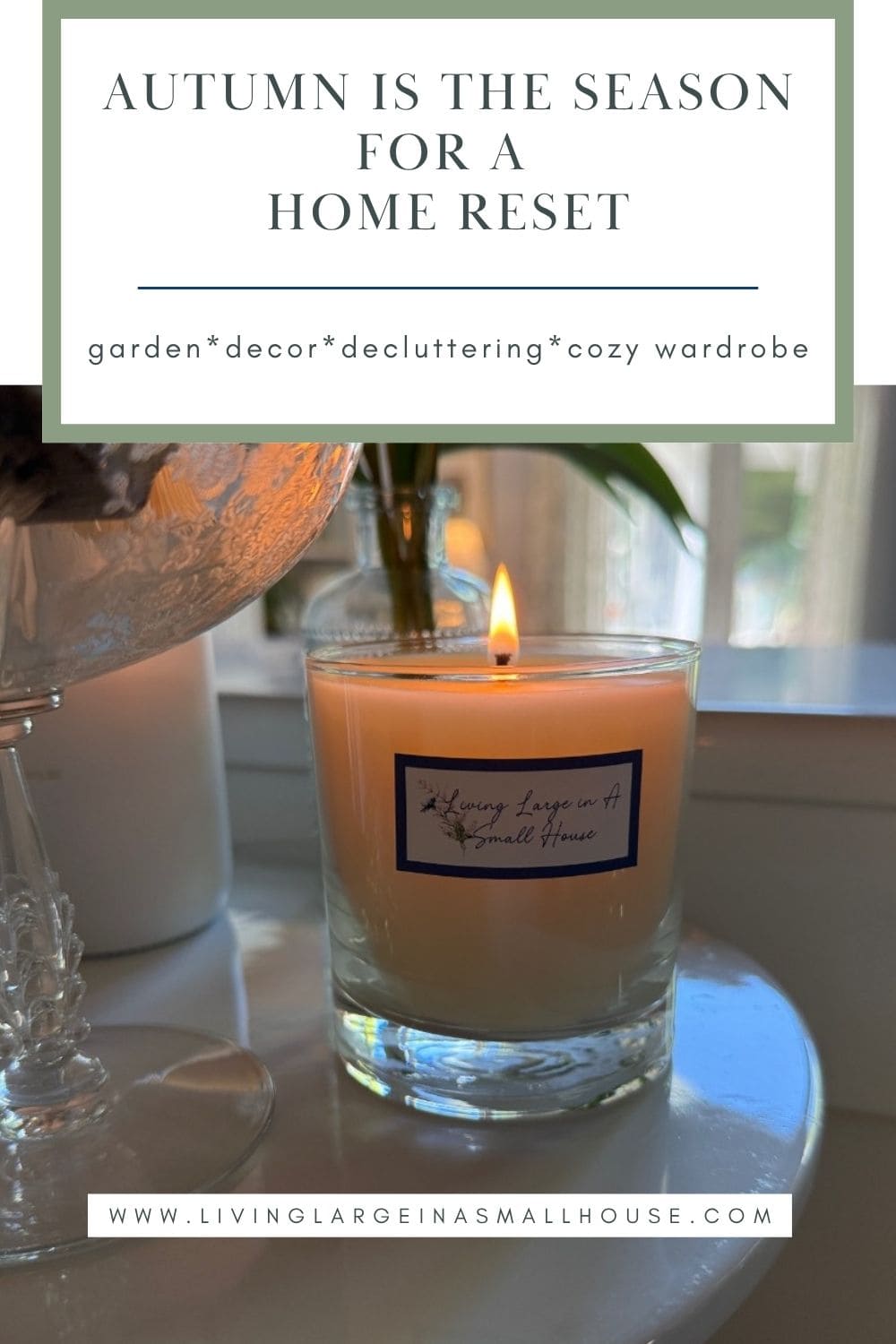 A lit candle on a table sets the mood for a cozy, decluttered space during your fall home reset.