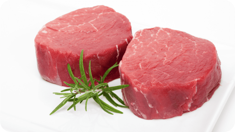 a uncooked beef tenderloin cut into filet steaks