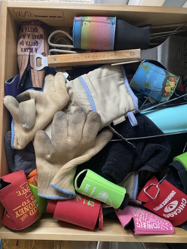very messy drawer that that needs kitchen organization