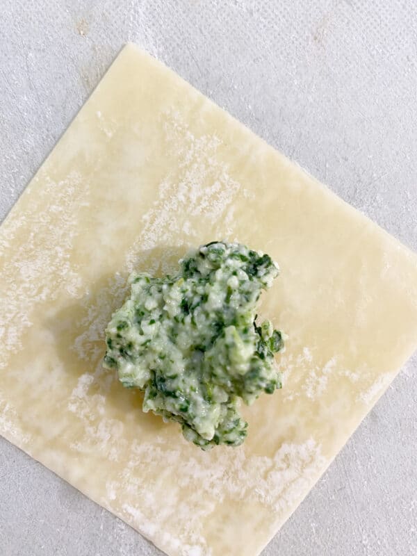 Put 1 tsp. of cheese/spinach mixture in center of wrapper