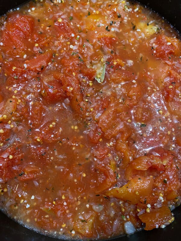 Onion and garlic with tomatoes added to pan