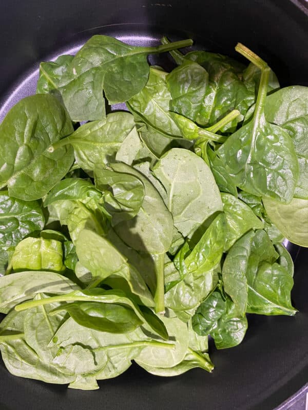 3 cups of fresh baby spinach in saute pan with a little oil