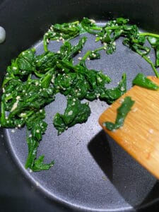 3 cups of baby spinach once it has been sautéed is about an 1/8th of the original size