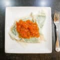 Homemade Spinach & Cheese Ravioli with tomato sauce on white square plate