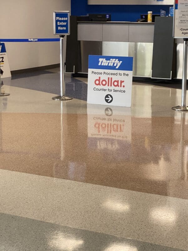 Empty Rental Counter with a Sign to get into the two hour long line