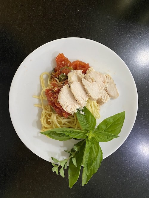 chicken breast with tomato basil sauce on pasta