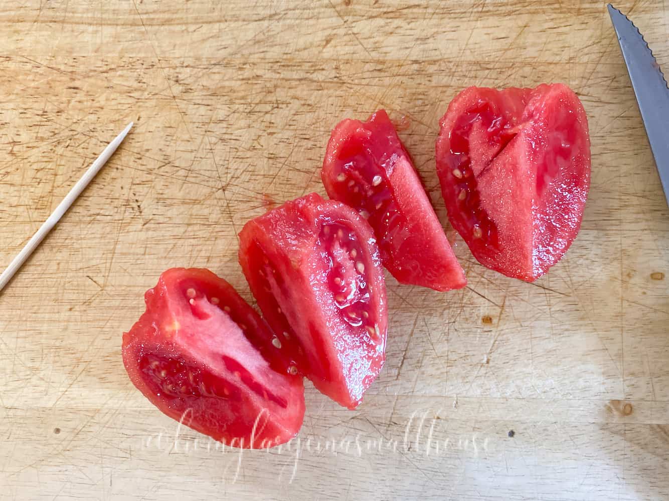 blanched, skinned tomato cut into quarters