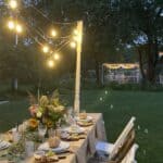 Al fresco Tablescape for fall with Edison light swag at dusk