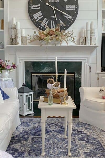 Farmhouse Living Room - White & Navy blue traditional rug with white sofa and chair flanking the fireplace made by my handy husband
