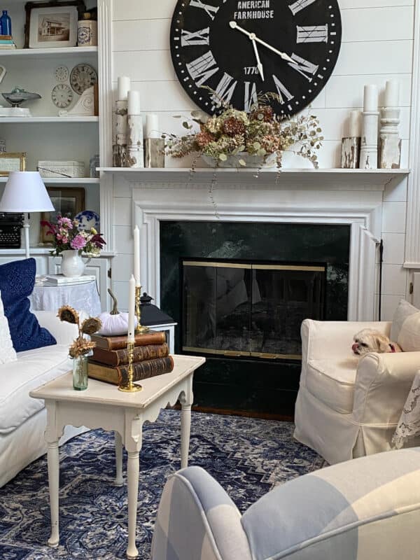 White & Navy Farmhouse living room White sofa and chair flank white mantel fireplace