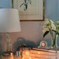 nightstand in bedroom with books and candle to make the space feel cozy and comfortable