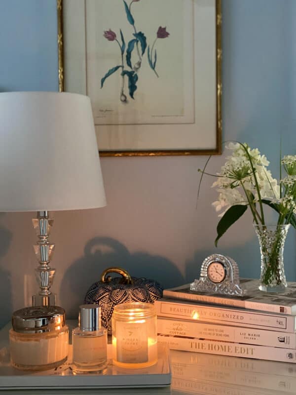 night stand in main bedroom with books and candle