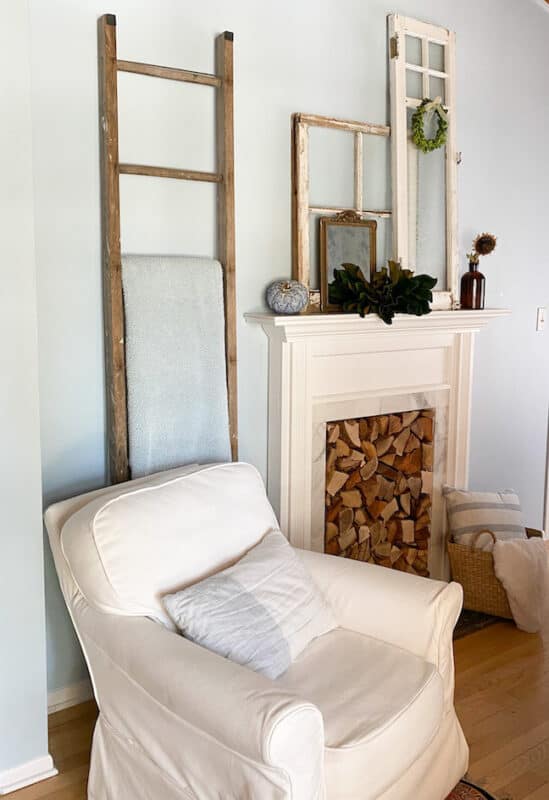 a chair with a pillow and throw for a little reading nook adds cozy to the bedroom