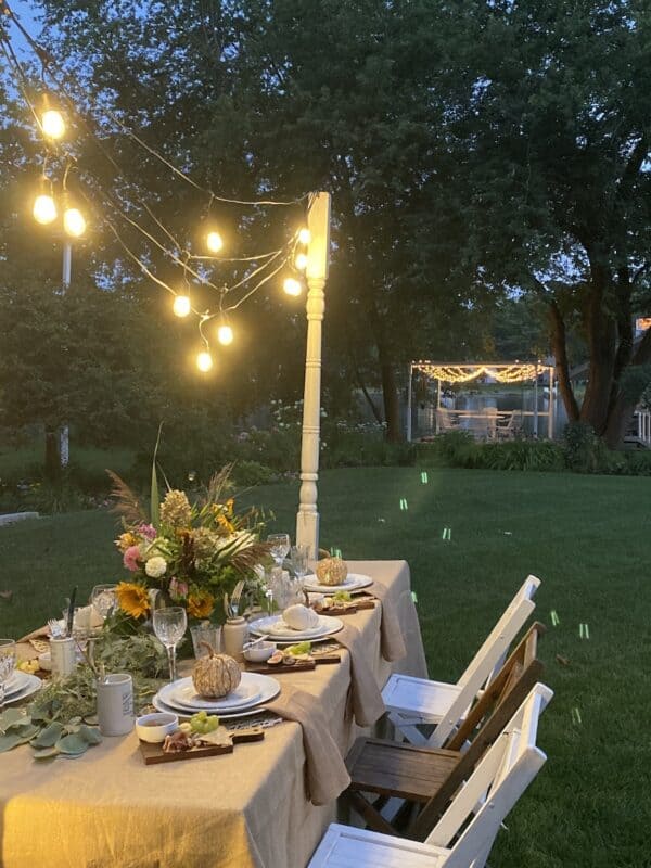 The harvest tablescape at night with the lighted dance floor from Annie's Wedding in the background