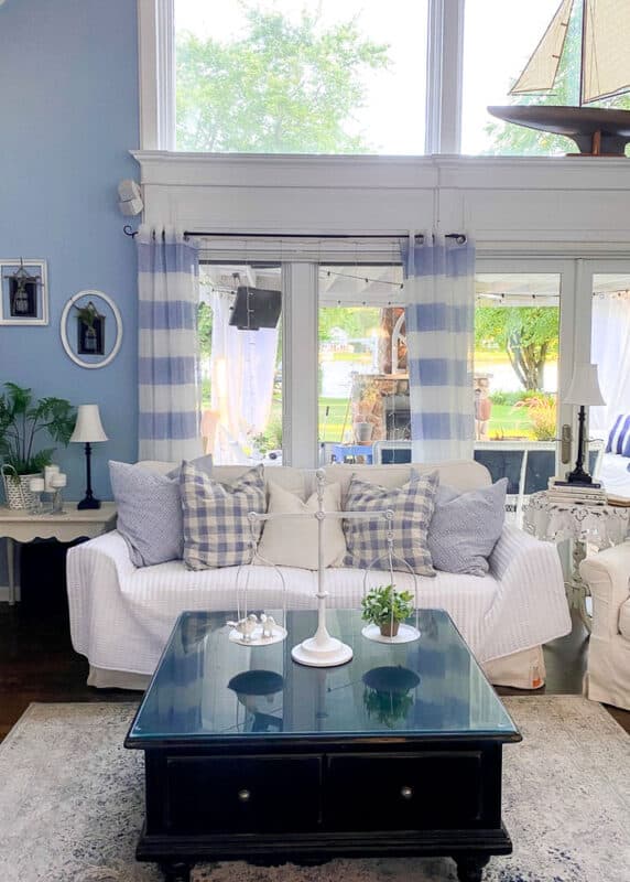 living room with white furniture and pier1 white and light navy area rug