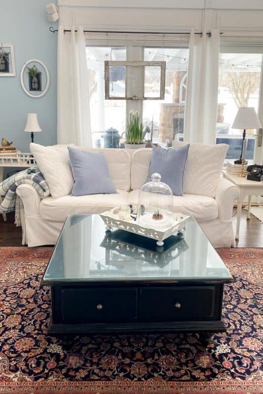 living room with white furniture and Persian rug