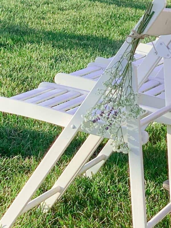 Baby's Breath and Lavender tied to white chairs for wedding 