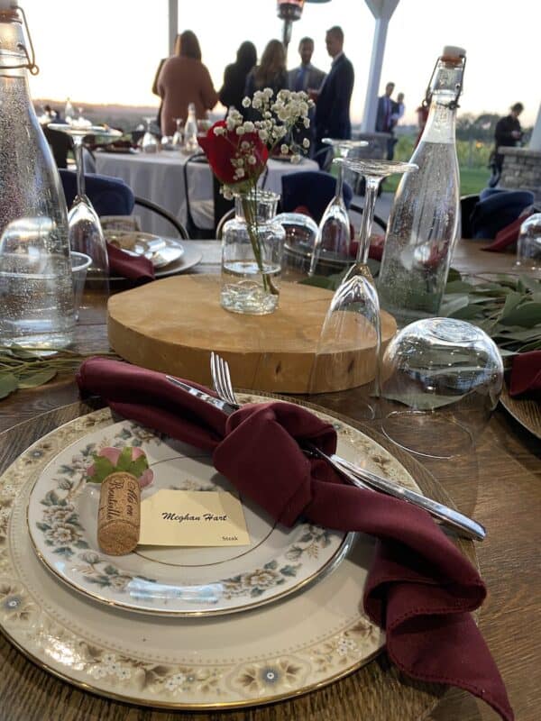 Table Setting with vintage plates and small bud vase arrangements