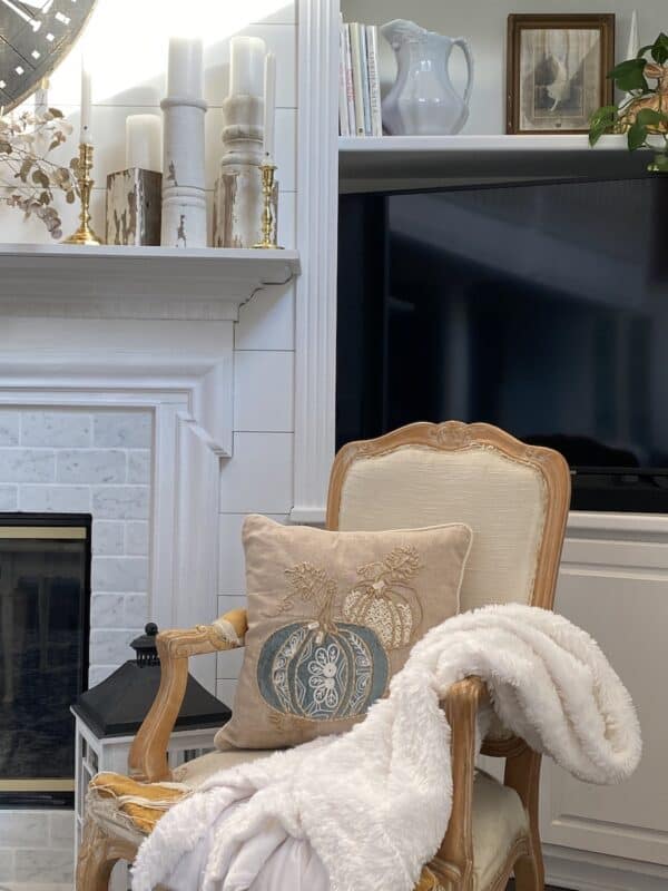 A corner of the fireplace with the new marble tiles and the old TV in the back corner