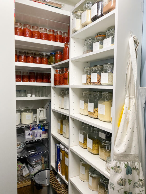 Pantry organized with glass containers and custom made Etsy labels