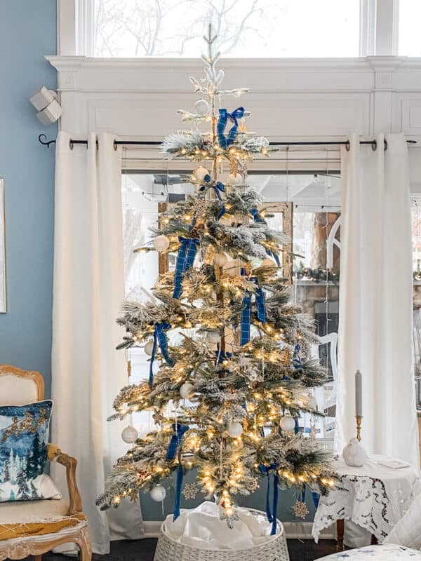 Fir Tree Christmas in front of window with white lights and blue & green plaid ribbons