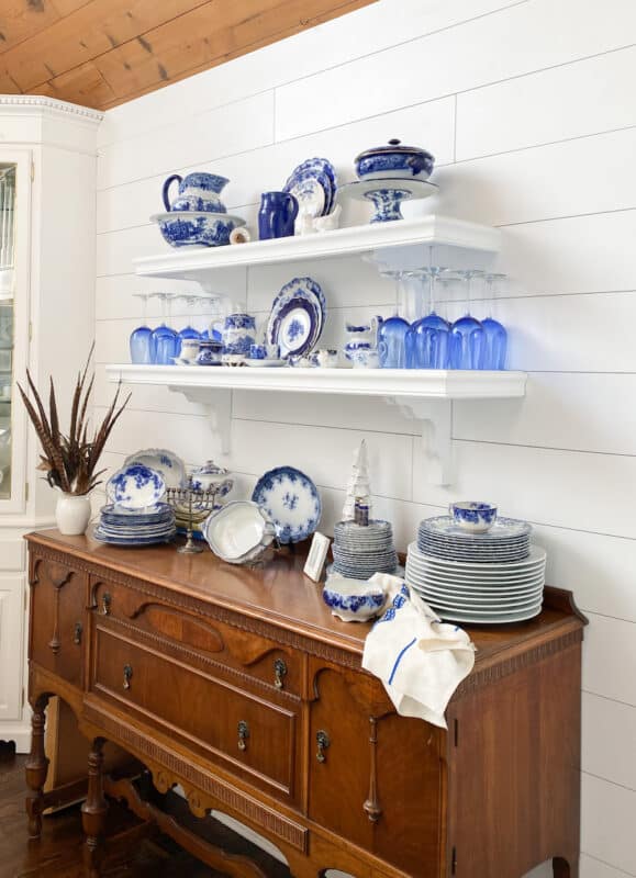 transformed shelves from black to white with flow blue china on them