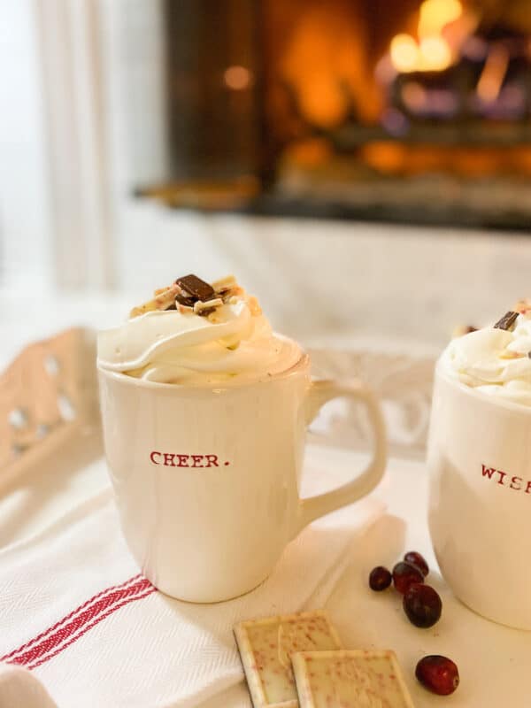 white mugs with baileys and coffee in front of the fireplace