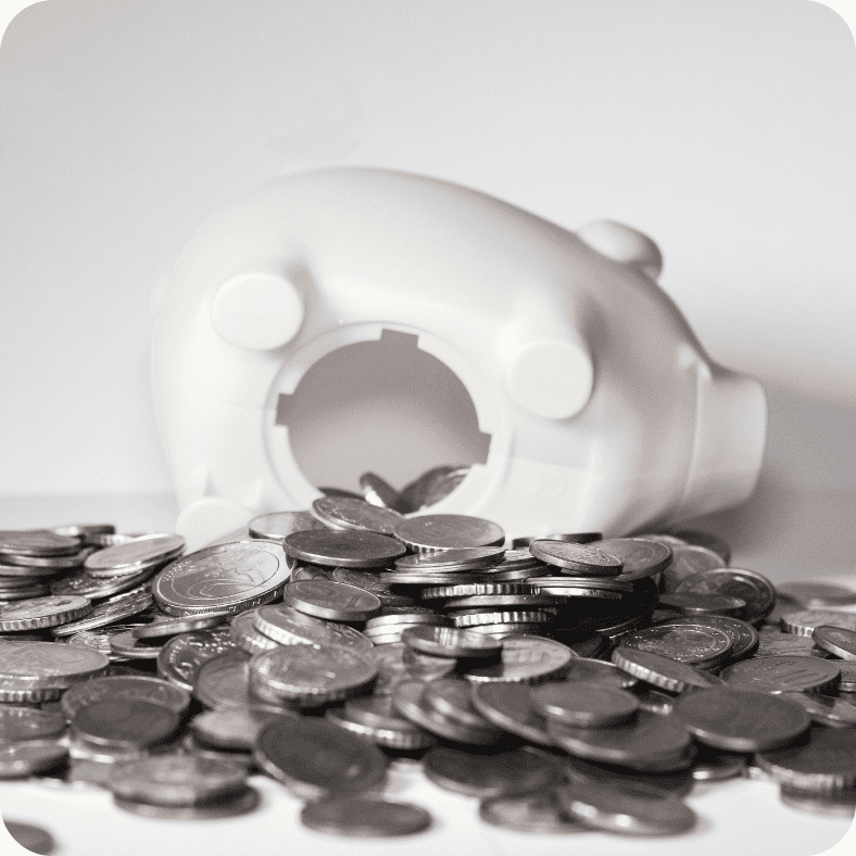 Ways to Easily Save Money - White piggy bank with money spilling out