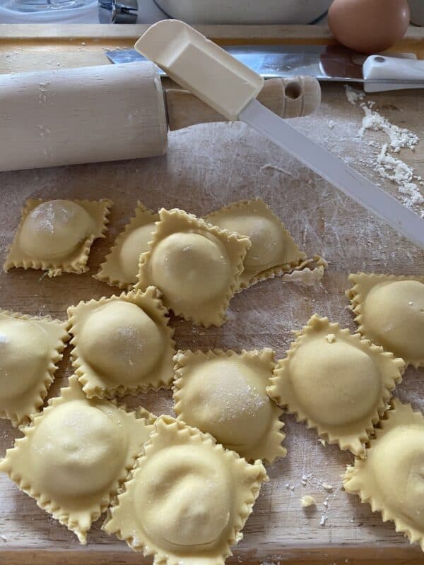 finished homemade cheesy lobster ravioli on cutting board
