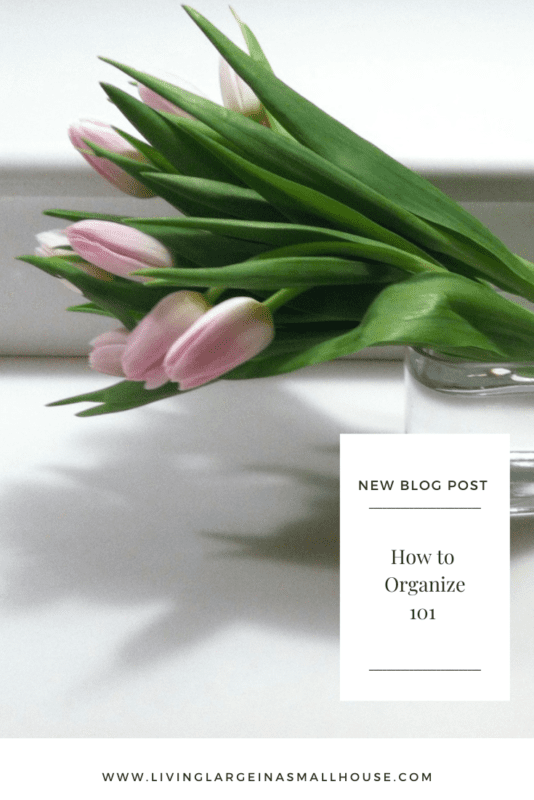Pinterest Pin with picture of pink tulips in glass vase on white countertop with overlay that reads "How to Organize 101"