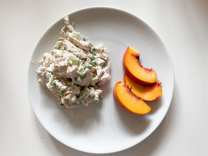 chicken salad with slices of peaches on the monthly meal planning guides