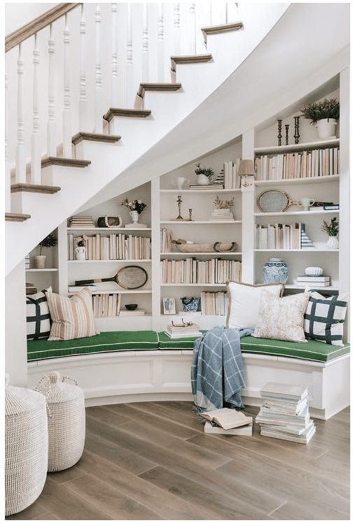 beautiful bookshelves and bench build-in under a spiral staircase