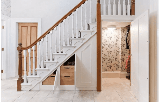 coat closet and cabinets built into the hidden storage in your home that is under your stairs