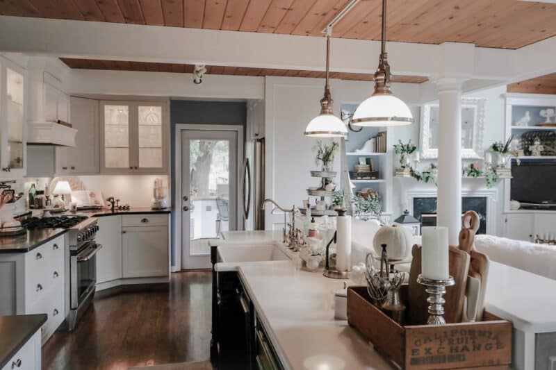 Finished kitchen white cabinets with black honed granite countertops, island with black cabinets and white quartz countertop