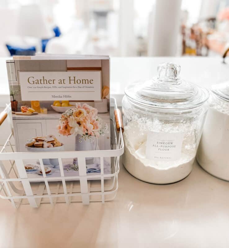 brightroom white metal basket with cookbooks stacked inside