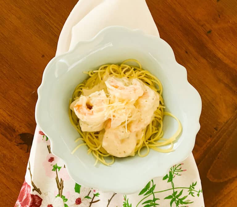 Easy Shrimp Alfredo with Angel Hair Pasta in a bowl on a floral napkin on the table