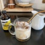 iced coffee on a black kitchen countertop with the Javy coffee bottle and a cream pitcher in the photo