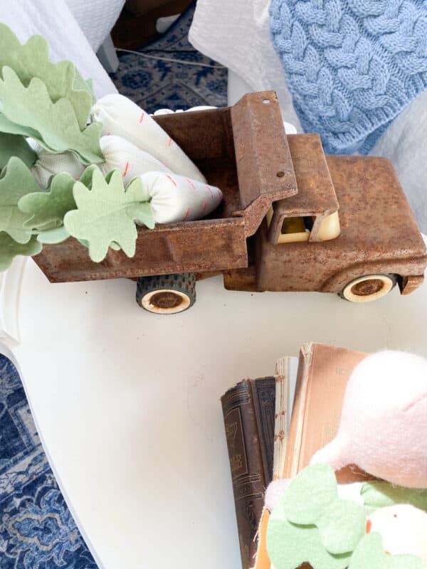 Coffee table with a vintage toy pick-up truck with some fabric carrots from target in the back of the truck all dressed for spring