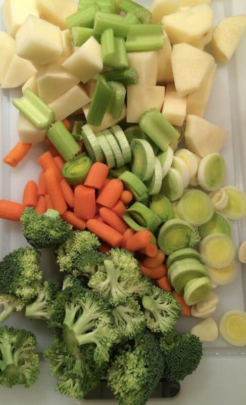 Cut up carrots, broccoli, leeks, celery and potatoes to put into a homemade soup