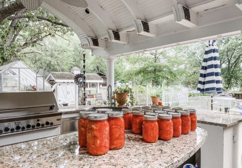 canned tomatoes on the counter of the outdoor kitchen. a necessary staple in a scratch cooks pantry
