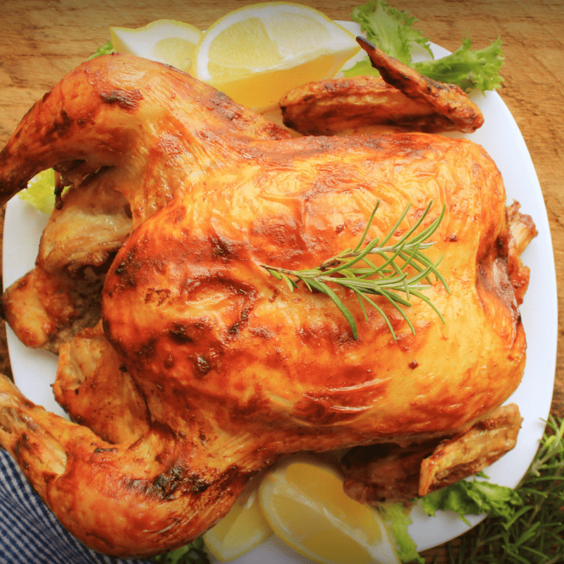 a beautiful roasted chicken on a white platter