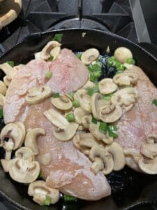 chicken breasts after they have been added to the skillet for a quick sear before going into the oven