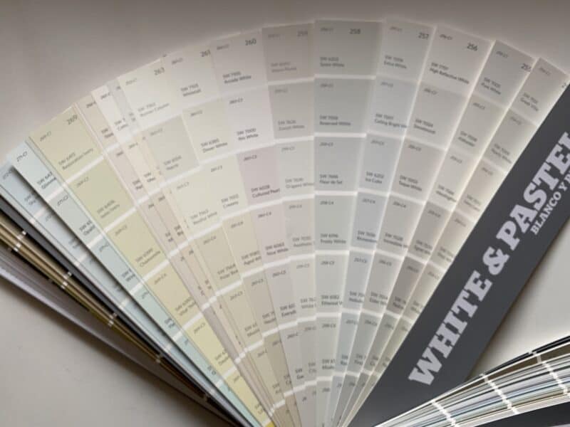 sherwin williams paint deck fanned out with all of the white shades and tints