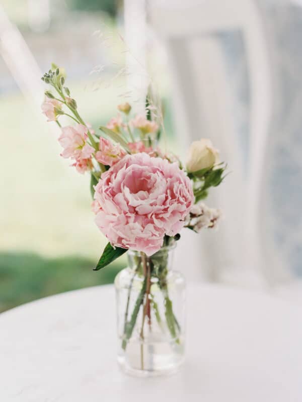 small floral arrangement of pink peonies with a few sprigs of other pink flowers for the intimate backyard wedding