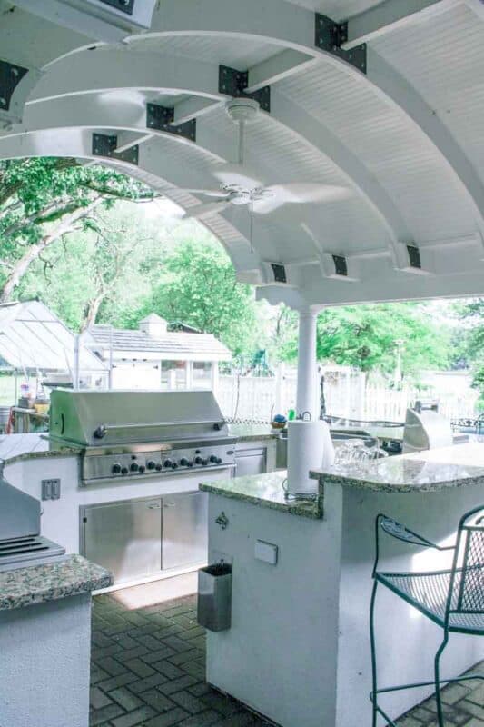 picture of our outdoor kitchen with a cove ceiling and built in grill