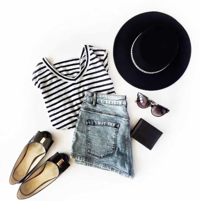 a picture of a black stripped t-shirt, jean shorts, black pumps, black sun glasses, a black hat and a black wallet. These are all part of my 10 perfect pieces for your summer capsule wardrobe