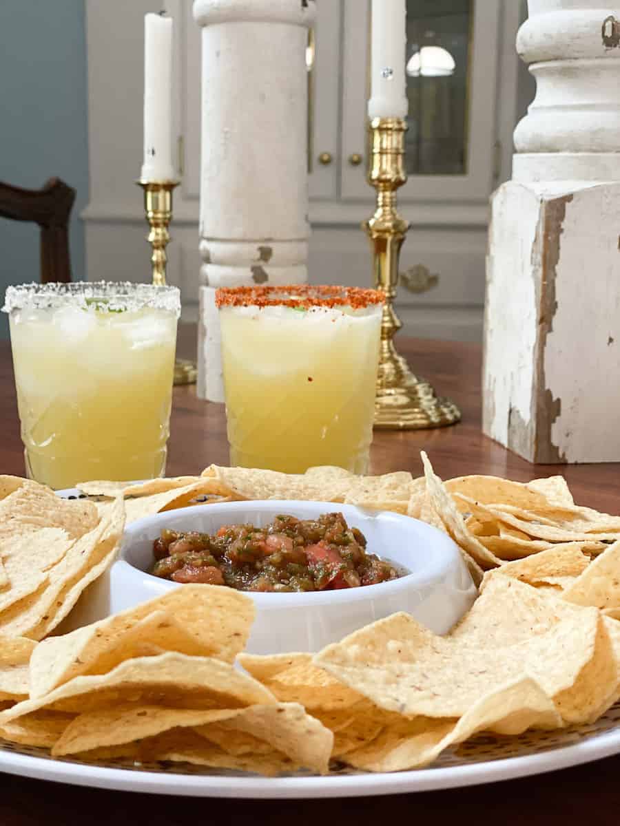 picture of my healthy restaurant style salsa with chips and two margaritas from a straight on view