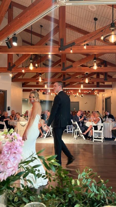 bride and groom walking out on to the dance floor. Wish we would have hired a wedding assistant for this big day